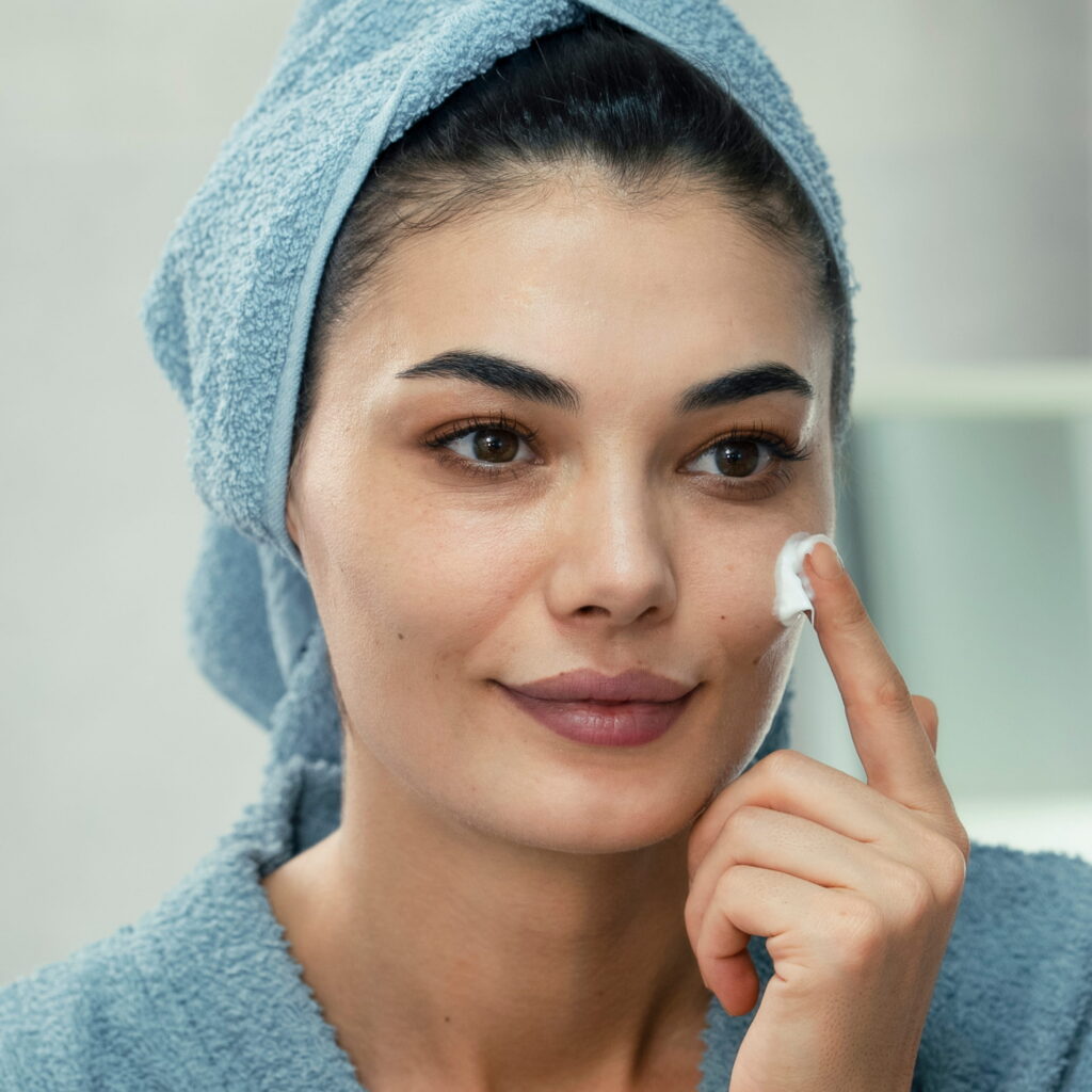 A woman applying the M.A.D Skincare Delicate Daily Moisturizer on her face