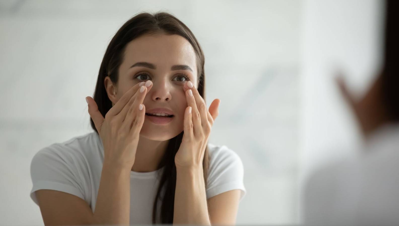 A woman applying M.A.D Skincare product on her face