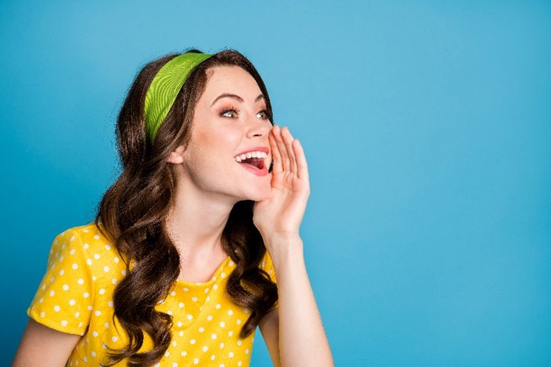A happy woman in yellow dress