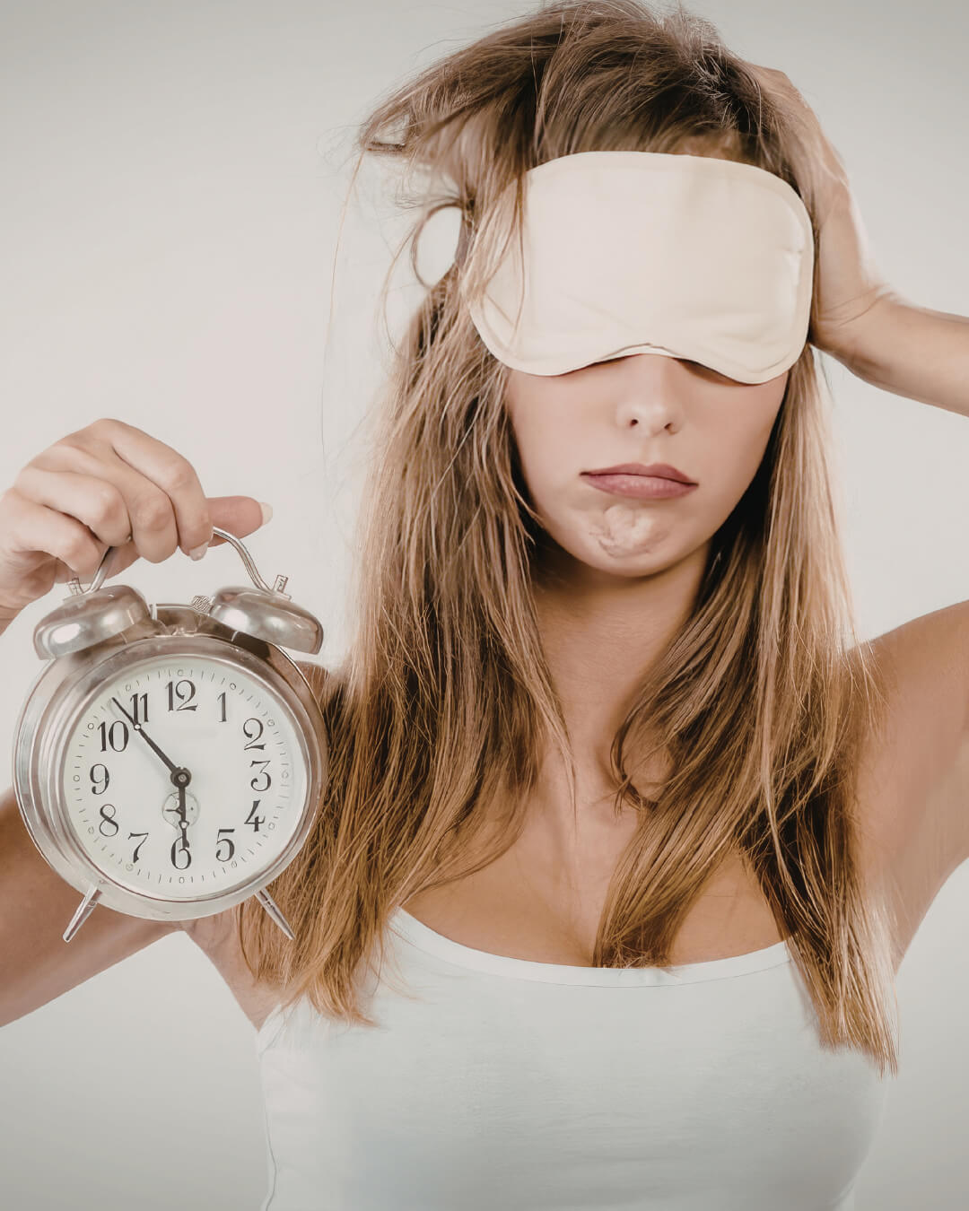 A girl holding clock in her hand