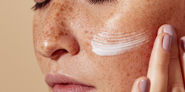 A woman applying oily skin moisturizer
